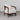 White Deren leisure chair photographed from the front in a grey studio setting