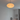 Silas D50 paper lantern pendant lamp glowing above a bed in a bright bedroom