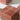 Close-up of a red travertine-look cube support under the glass top of the Jupiter 120 coffee table