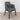 Simone dark grey dining chair standing on a woven natural rug against a light grey wall